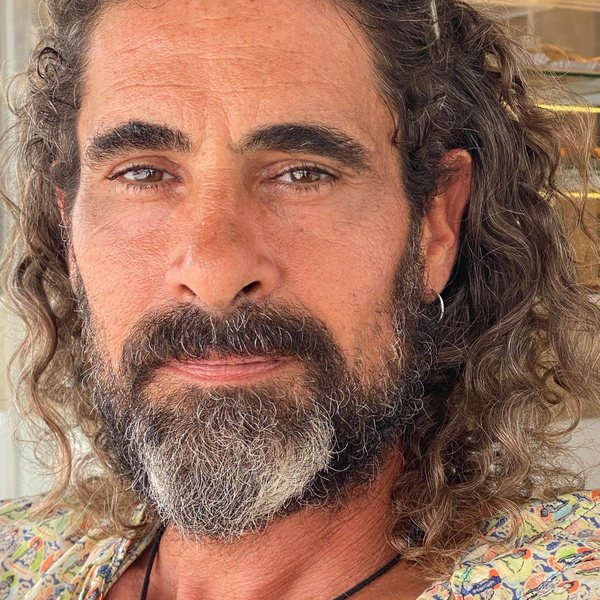 Portrait of Xabi Soler, curly hair and a grey-flecked beard, looking calmly at the camera.